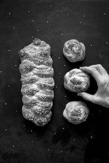 Overhead shot of a loaf of cardamom bread and three buns