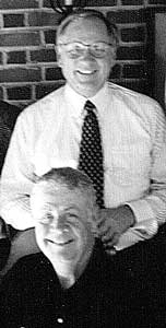 Arne Carlson and Art Mampel, one standing behind the other, both smiling