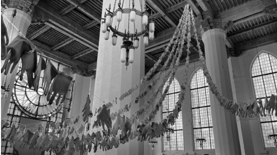 Photo of the interior of St. Marks, strands of cotton gloves hung on lines